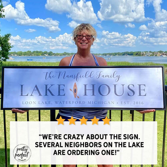 happy customer holding personalized lake house canvas sign with custom family name waterfront home decor testimonial photo