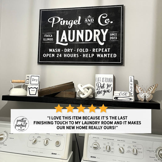 Personalized farmhouse laundry room wall sign reading “Pingel and Co. Laundry” above washer and dryer with rustic decor, adding a stylish custom touch to a laundry space
