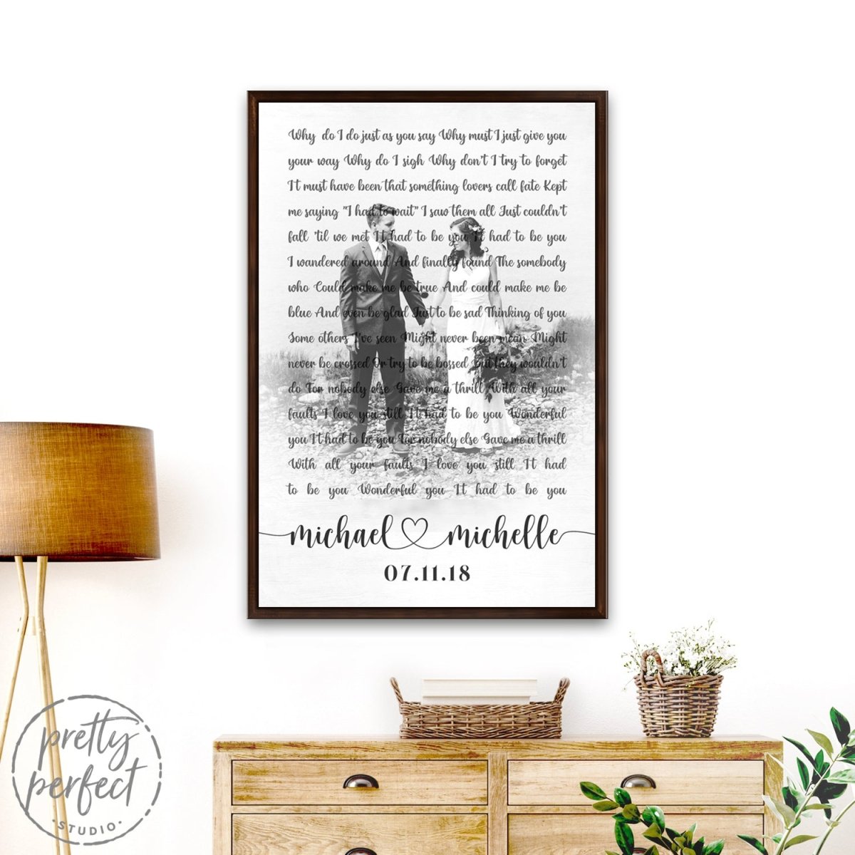 Personalized wedding song lyrics canvas with photo, names, and date, on wall above dresser with lamp and decor