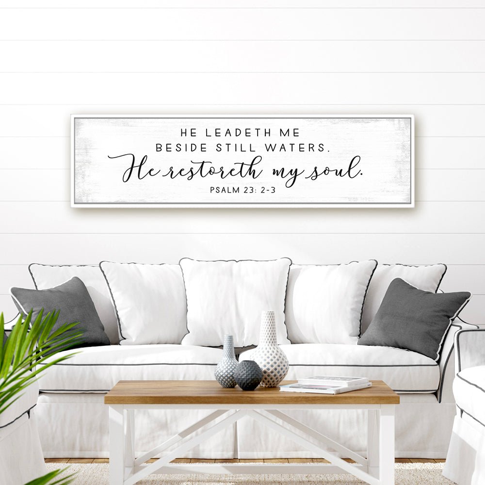 He Leads Me Beside Still Waters Psalm 23 Bible Verse Sign Hanging on the Wall Above Couch - Pretty Perfect Studio