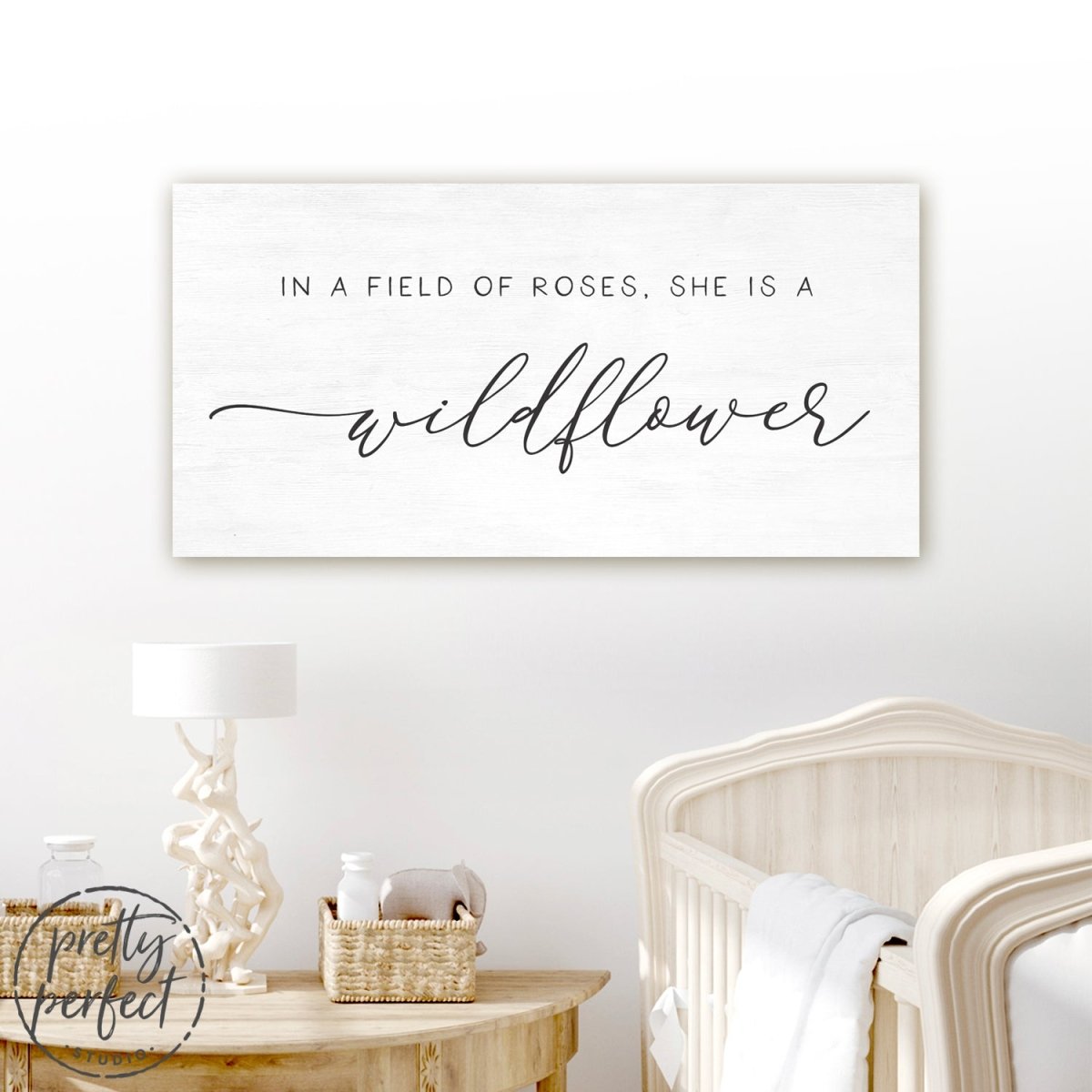 In A Field Of Roses She Is a Wildflower Sign Hanging Above Baby Crib - Pretty Perfect Studio