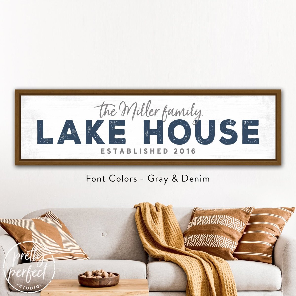Lake House Sign Personalized With Family Name in a lakeside home interior styled above a modern sofa