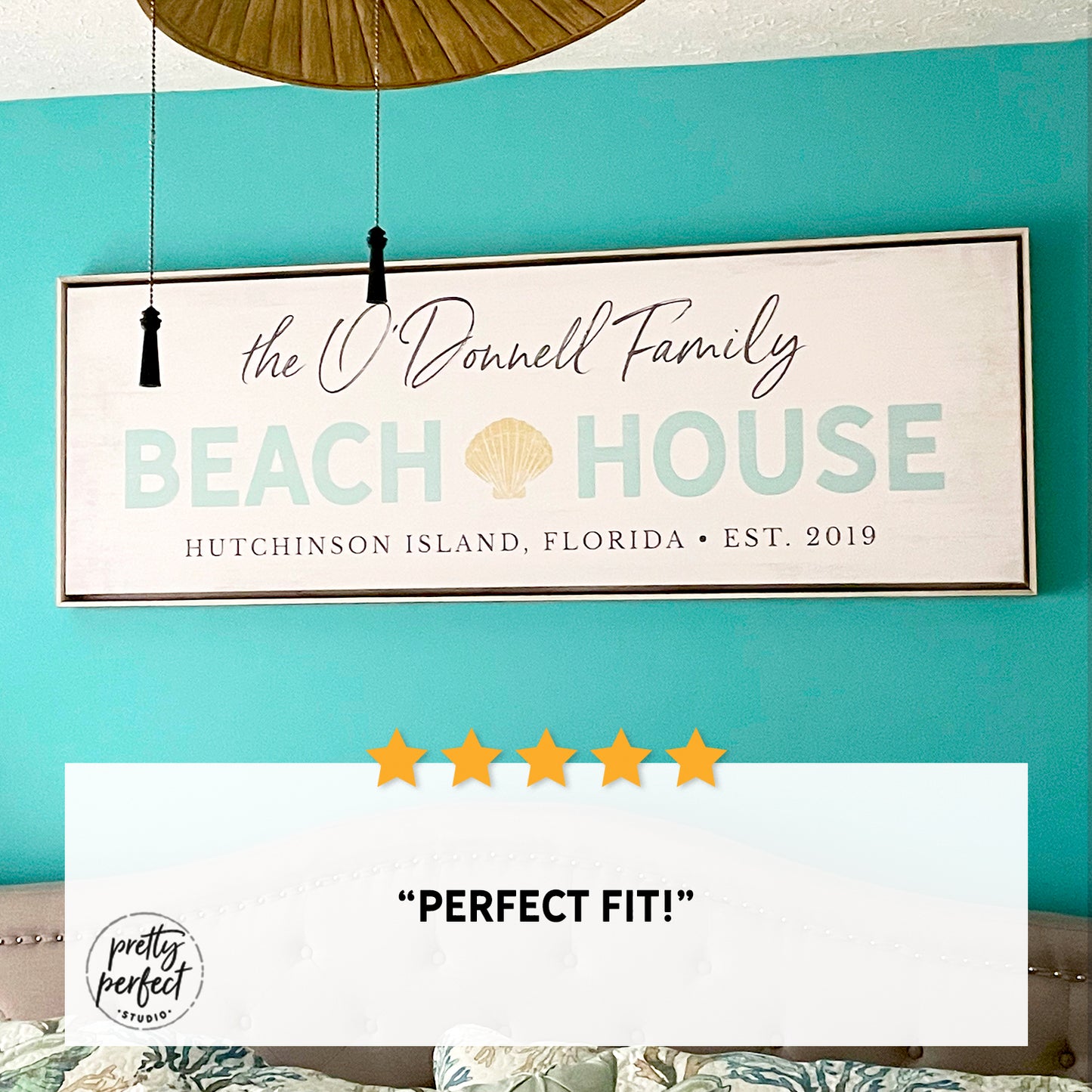 personalized beach house sign with family name, custom coastal wall art with shell design and location, beach home decor above bed, seaside family name sign for vacation home, customer review photo showing framed beach house sign in bedroom