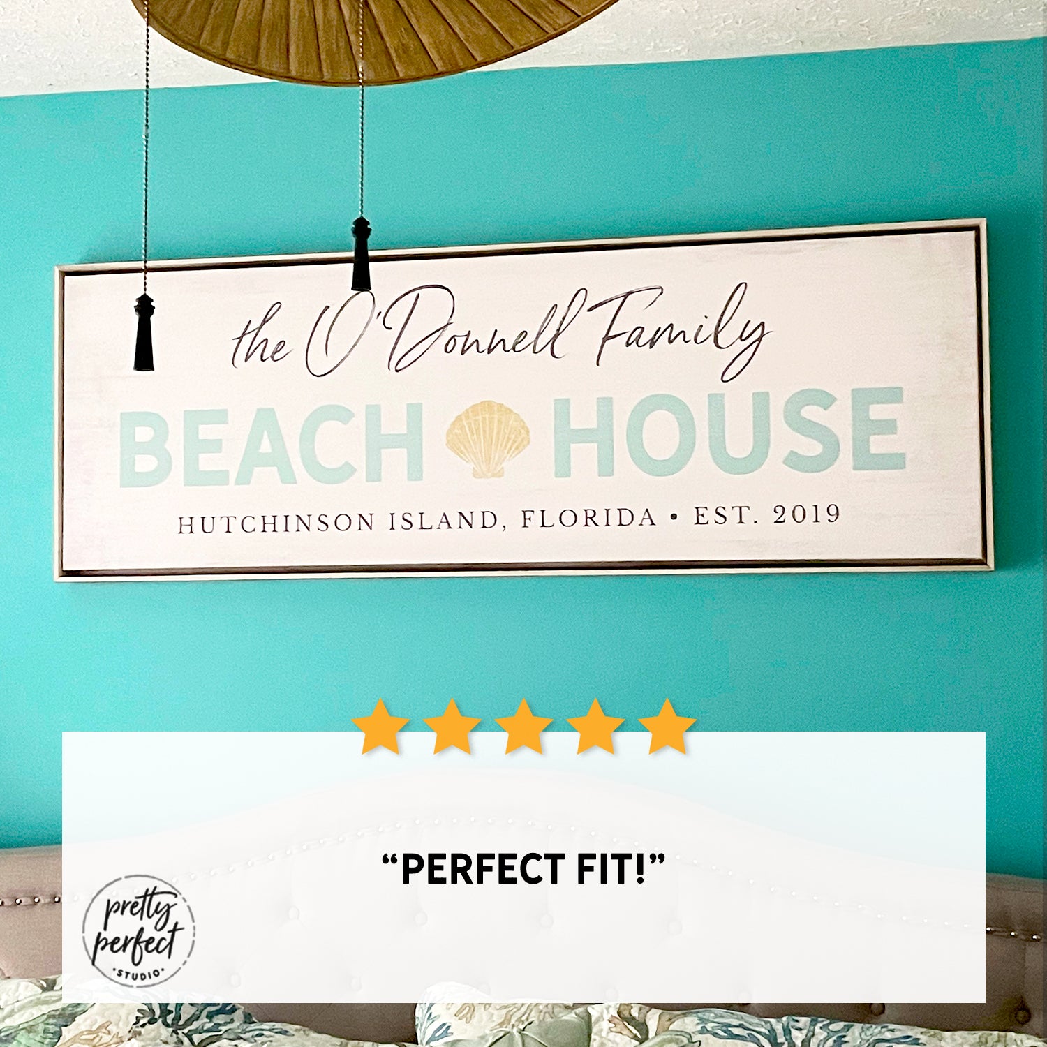 personalized beach house sign with family name, custom coastal wall art with shell design and location, beach home decor above bed, seaside family name sign for vacation home, customer review photo showing framed beach house sign in bedroom