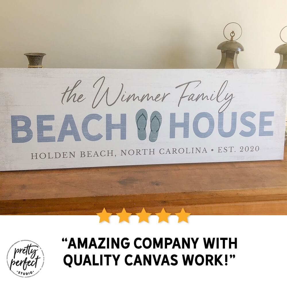 personalized beach house sign with family name, custom coastal wall art with flip flop design and location, beach home decor sign for vacation house, seaside family name sign gift, customer review photo showing beach house canvas on table