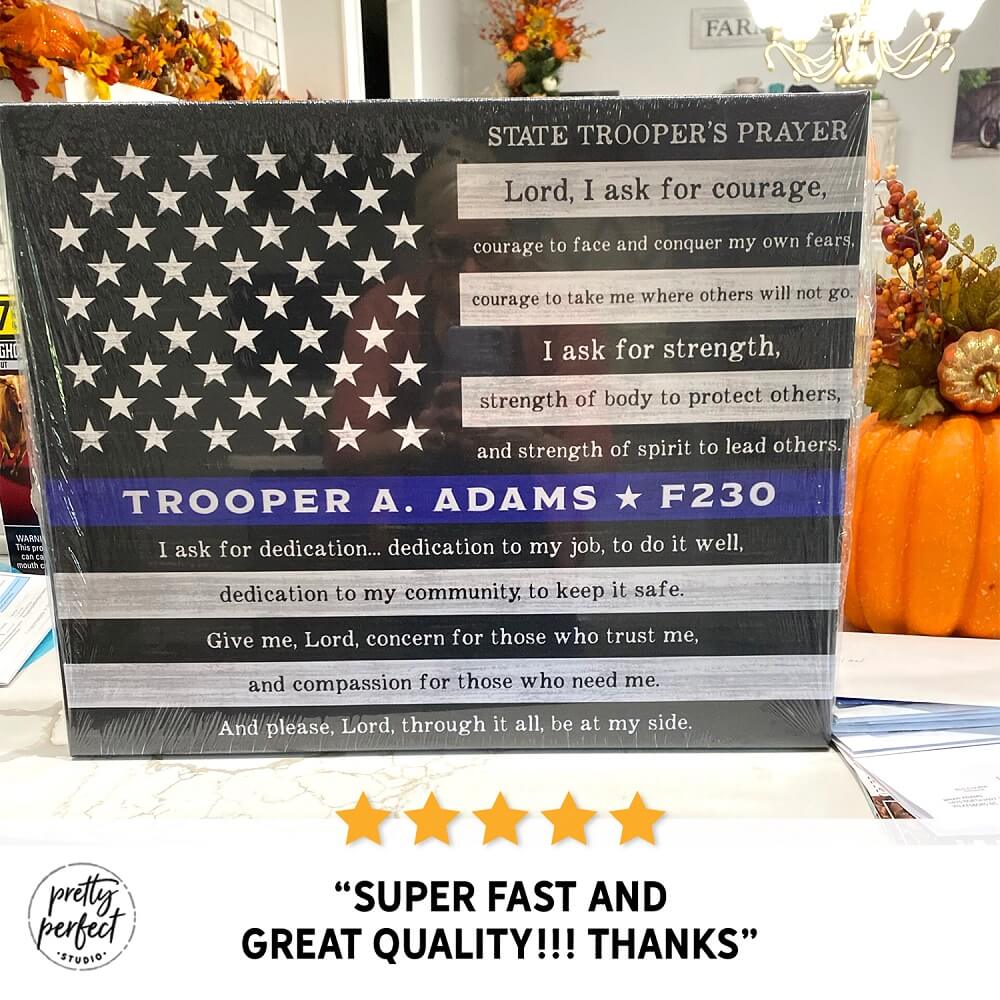 American flag-themed product with text and star design, placed on a surface with pumpkins and other items.