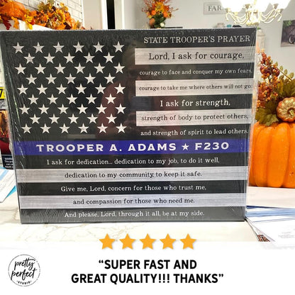 American flag-themed product with text and star design, placed on a surface with pumpkins and other items.