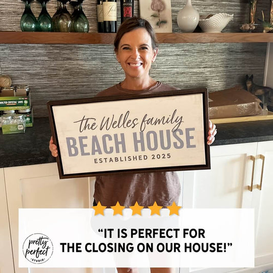 Custom beach house wall sign displayed in a cozy coastal living room setting
