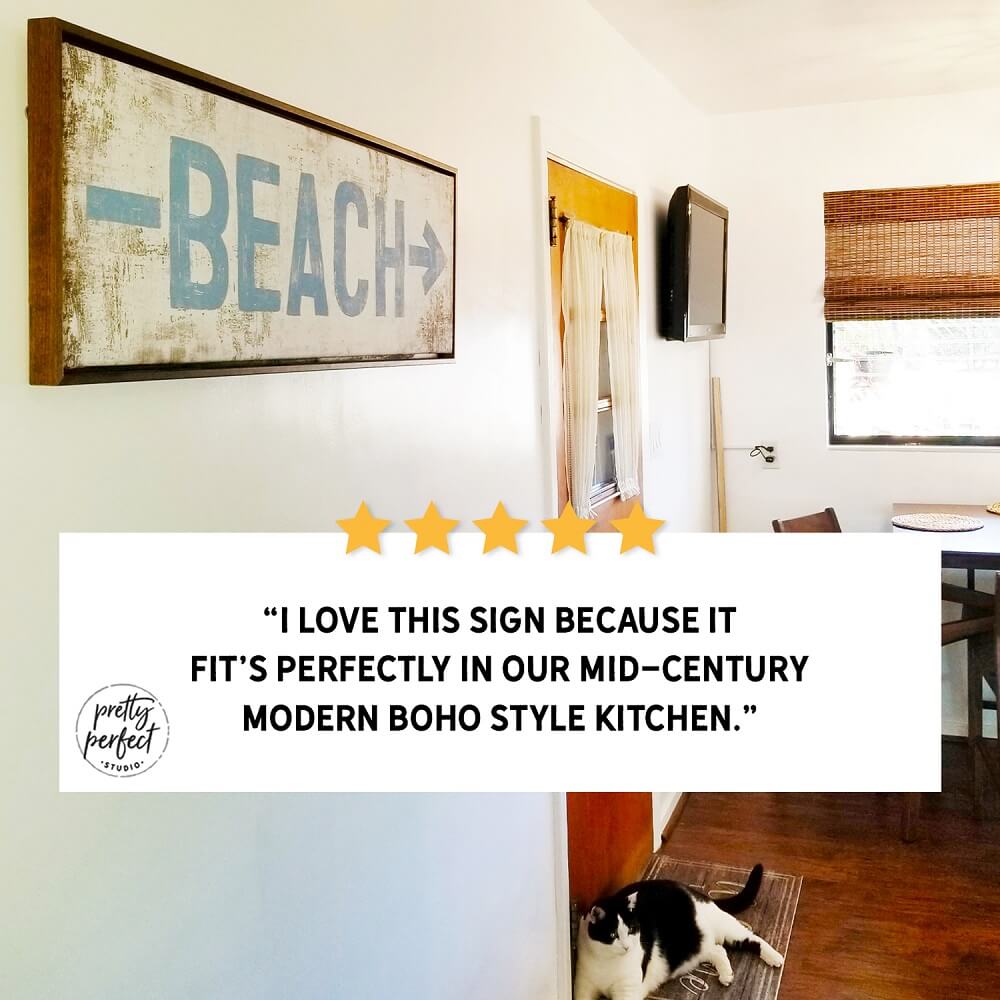 Beach sign in a mid-century modern boho style kitchen with a cat on the floor.