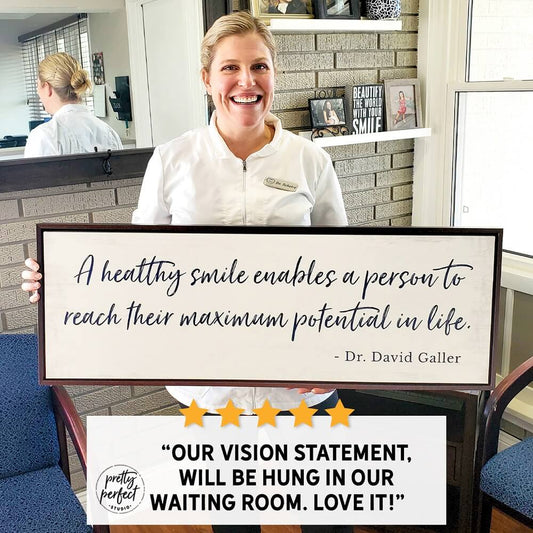 Customer holding custom business quote wall art sign displayed in office waiting room decor with five star review