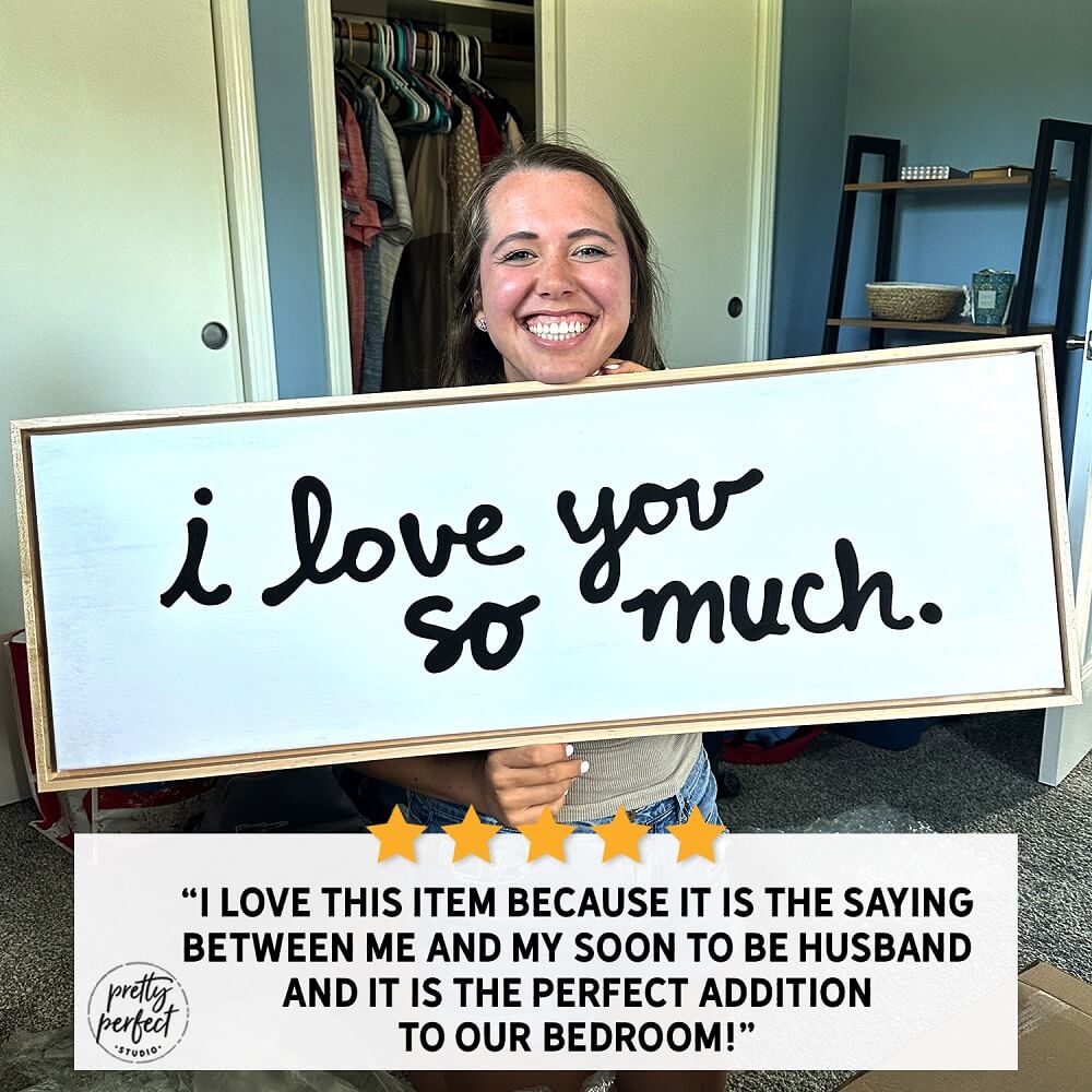 Customer holding a personalized 'I love you so much' wooden sign, perfect for bedroom décor