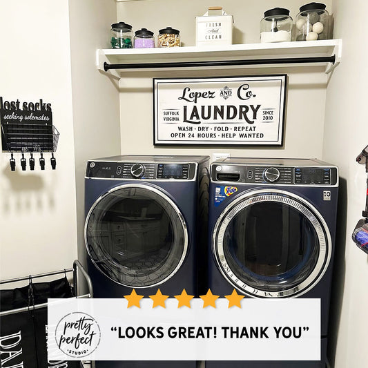 Farmhouse laundry room with washer and dryer and “Laundry Co.” wall sign, modern rustic laundry decor with shelf storage jars and clean organized space