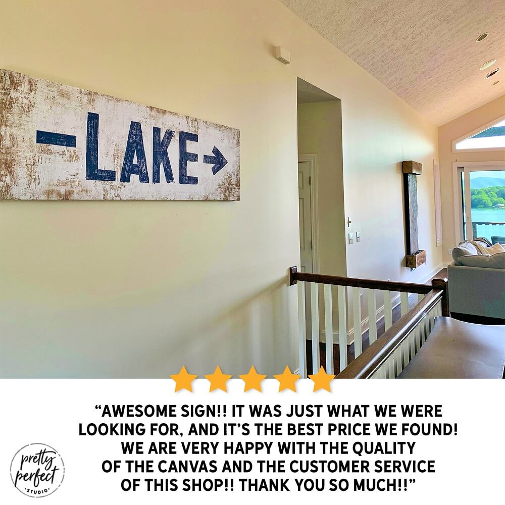 Lake arrow sign styled in a cabin entryway with warm wood accents
