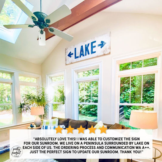 Lake arrow sign displayed in a bright modern living room above a couch