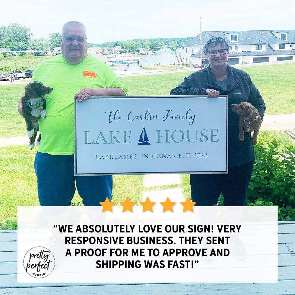 couple holding personalized lake house canvas sign with custom family name waterfront decor customer testimonial photo