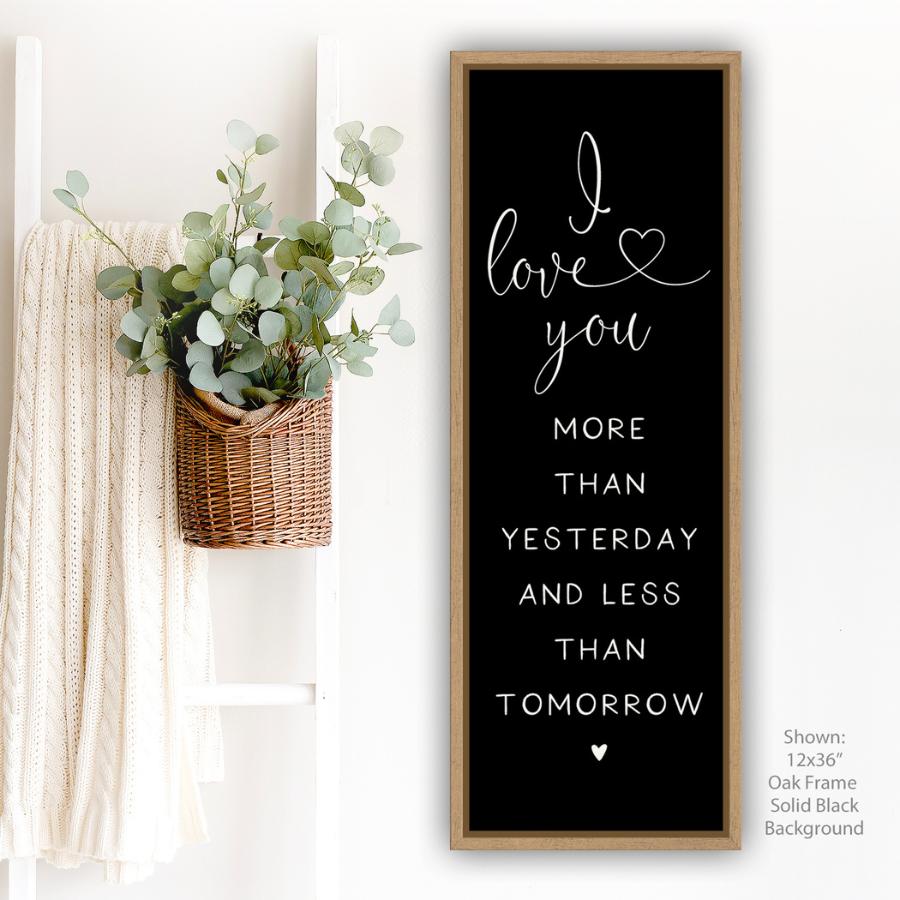 vertical canvas wall art romantic quote sign black background with oak frame “I love you more than yesterday and less than tomorrow” for bedroom or couple home decor