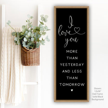 vertical canvas wall art romantic quote sign black background with oak frame “I love you more than yesterday and less than tomorrow” for bedroom or couple home decor