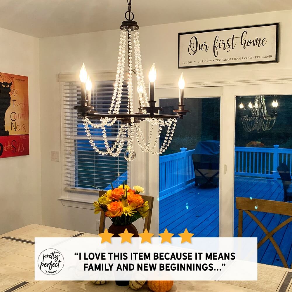 personalized home coordinates sign with our first home text and custom GPS coordinates displayed above dining room window in cozy home setting