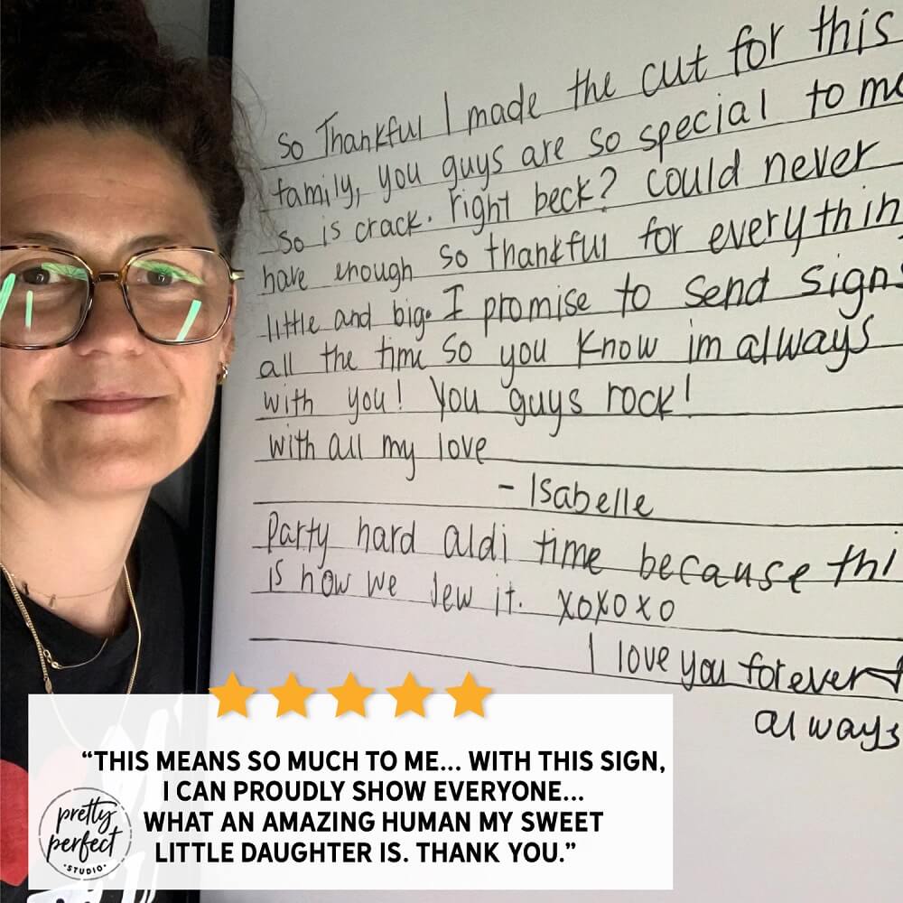 Customer holding a personalized handwritten sign for home, adding a personal touch to any space