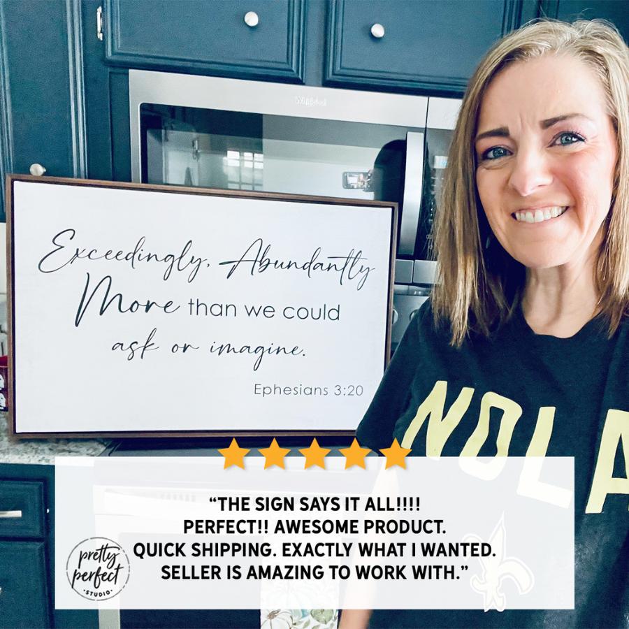 Happy customer holding personalized scripture wall art with positive review