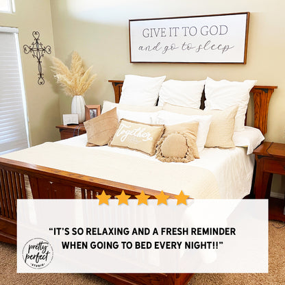 Review of bedroom canvas sign with a framed quote "Give it to God and go to sleep" on the wall.