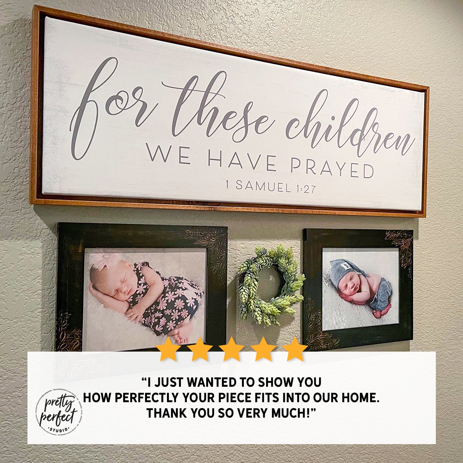 Decorative wall sign with framed baby photos and a wreath, featuring a quote from 1 Samuel 1:27 "For these children we have prayed".