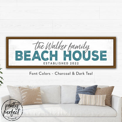 Coastal living room decor featuring a personalized beach house wall sign