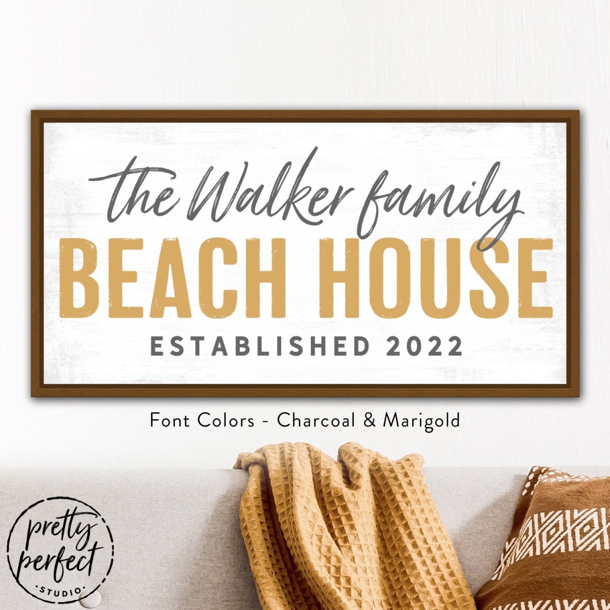Custom beach house sign styled above couch with rustic look