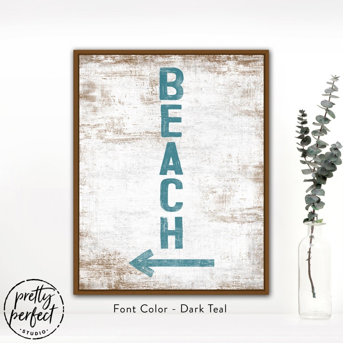 framed beach sign wall art with rustic wood background and teal text