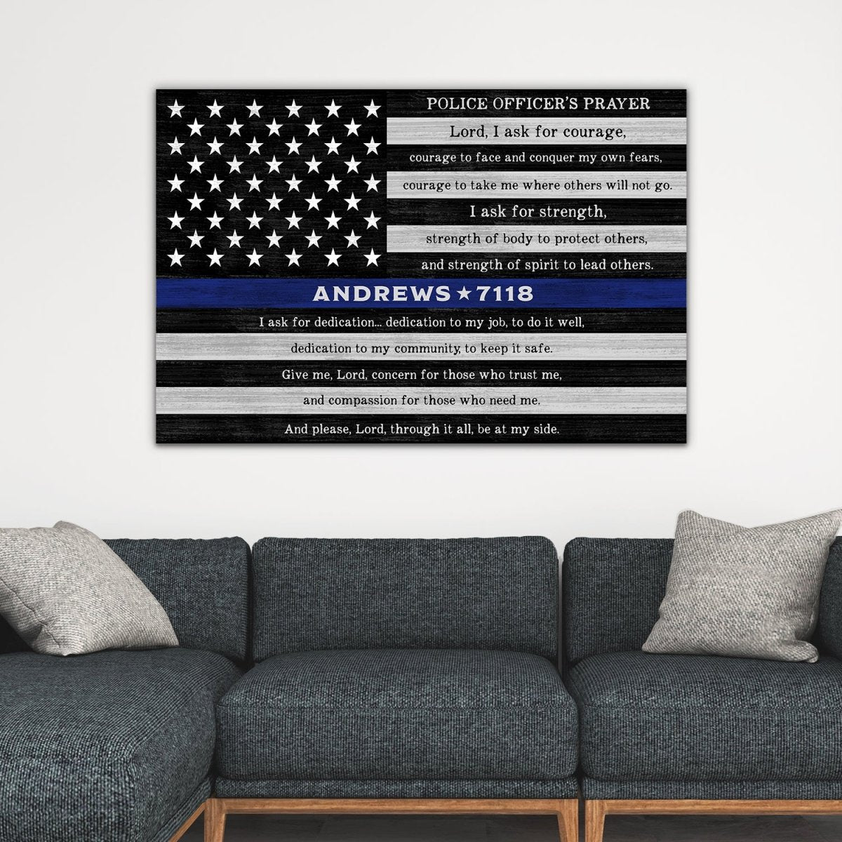 Personalized police officer prayer wall art with name and badge number above gray couch, thin blue line canvas decor for living room or law enforcement gift
