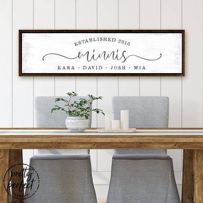 custom last name sign with family members names and established date in modern rustic typography on light distressed background above dining table