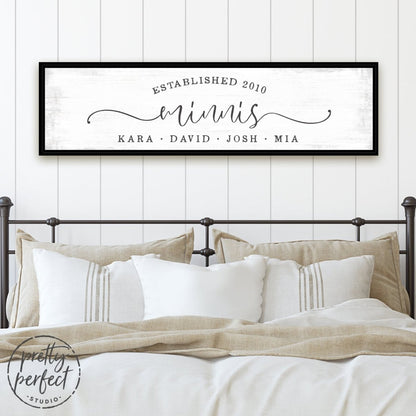personalized family name wall art with last name, est year, and custom quote on lightly distressed canvas in modern bedroom