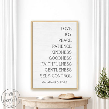 Fruit Of The Spirit Canvas Sign With White Frame Hanging On Wall Above Plant Decoration - Pretty Perfect Studio