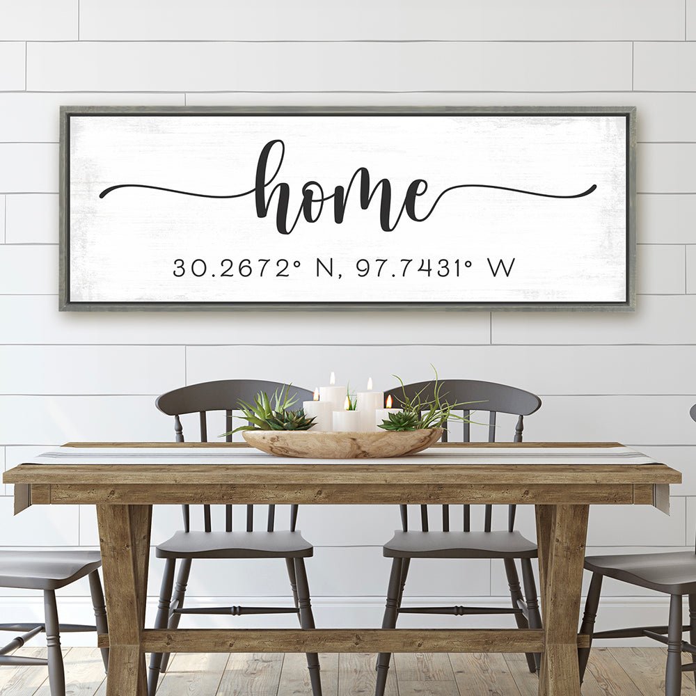 personalized home coordinates sign with distressed white background above rustic dining table with modern farmhouse decor