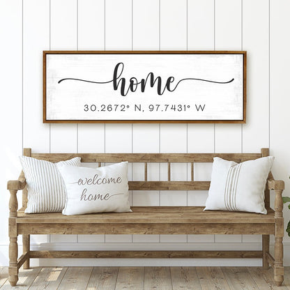 personalized home coordinates sign with distressed white background above wooden bench in farmhouse entryway