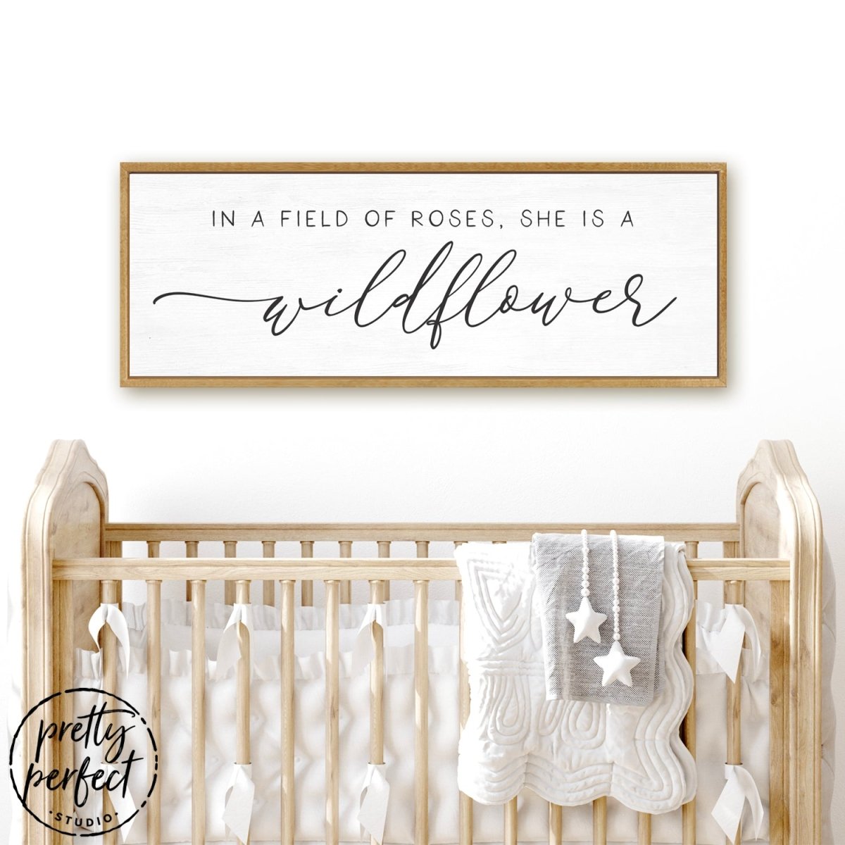 In A Field Of Roses She Is a Wildflower Sign Hanging Above Baby Crib - Pretty Perfect Studio