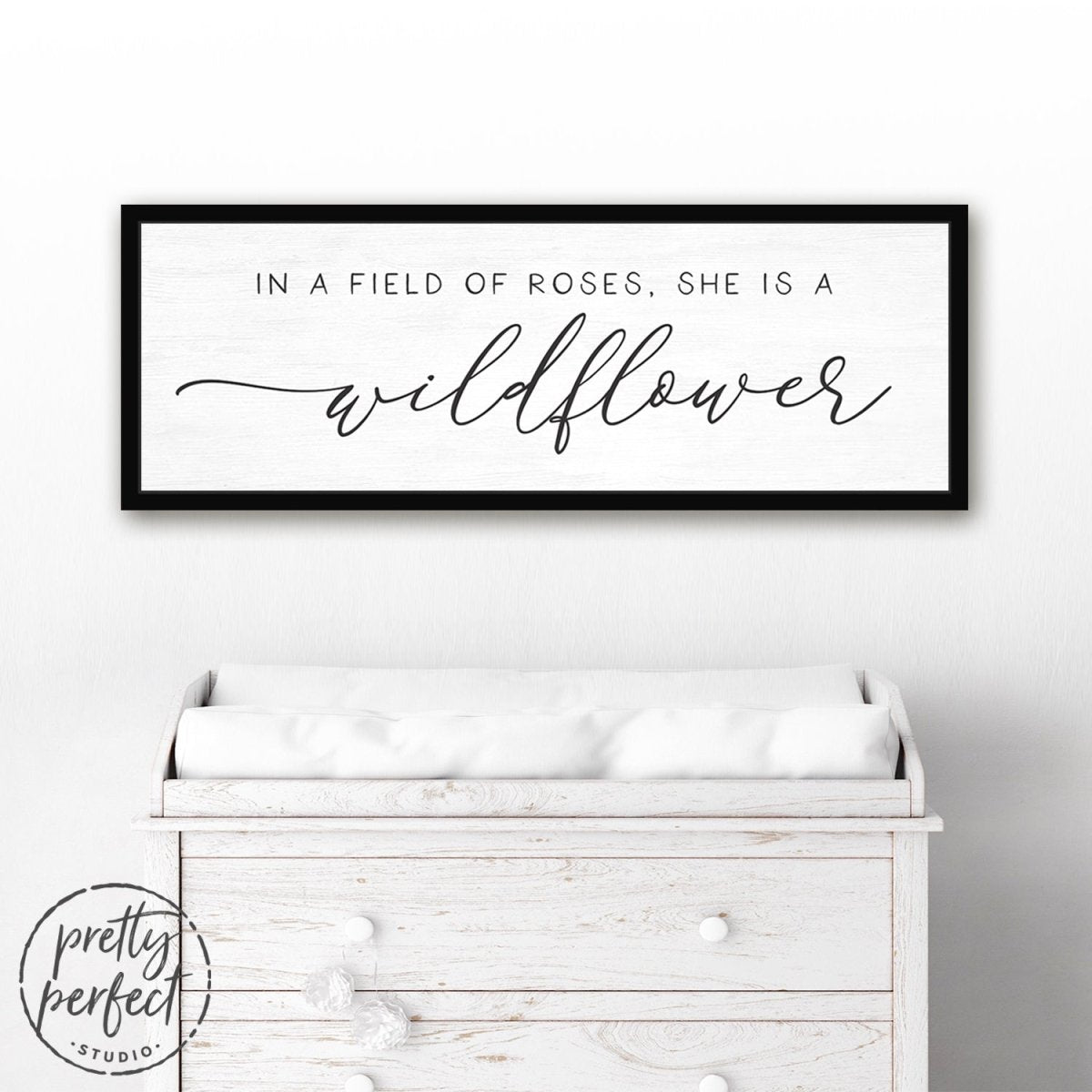 In A Field Of Roses She Is a Wildflower Sign Hanging Above Dresser - Pretty Perfect Studio