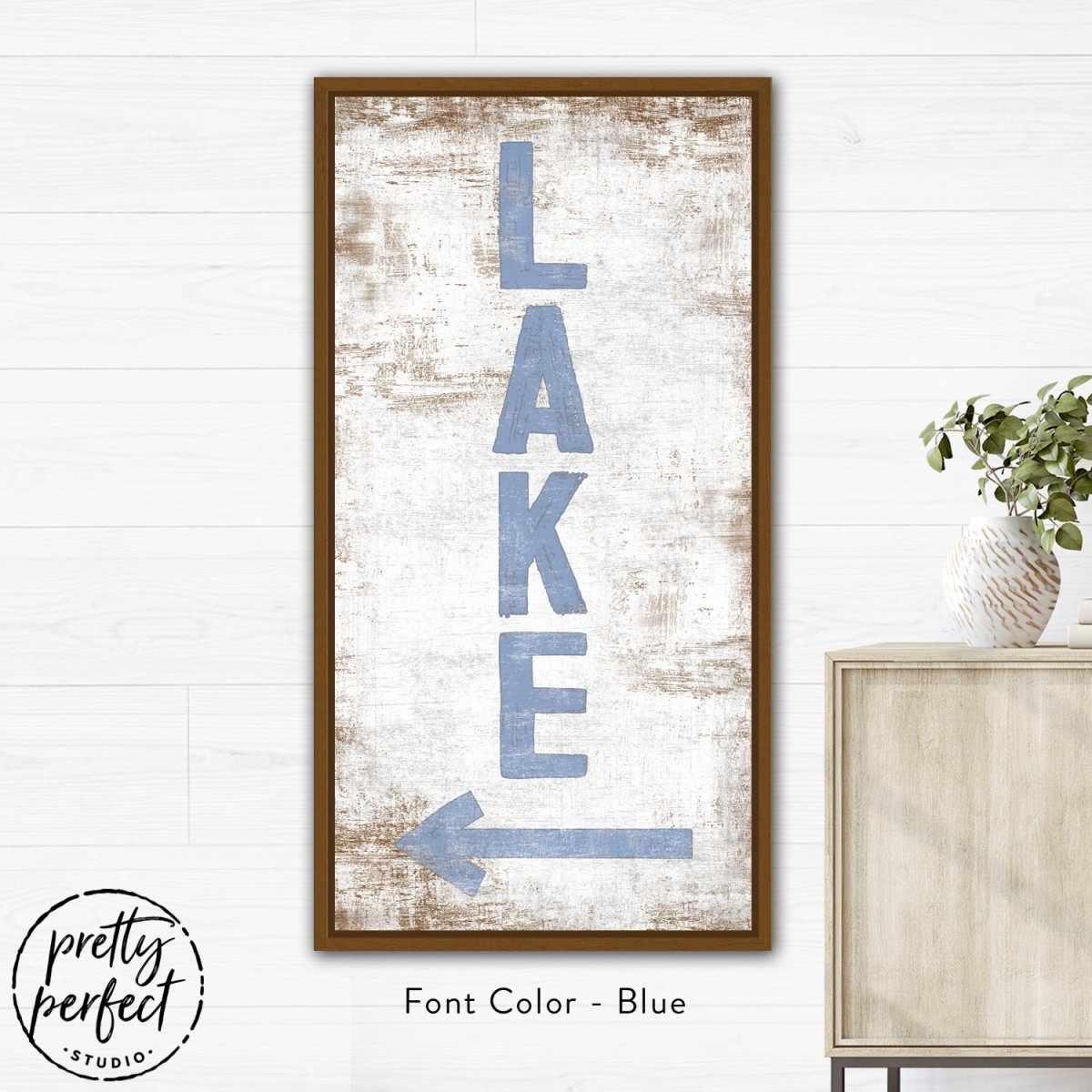 Close-up of lake sign showing distressed wood grain and bold lake lettering