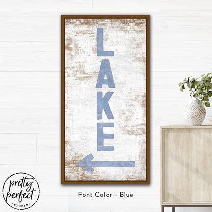 Close-up of lake sign showing distressed wood grain and bold lake lettering