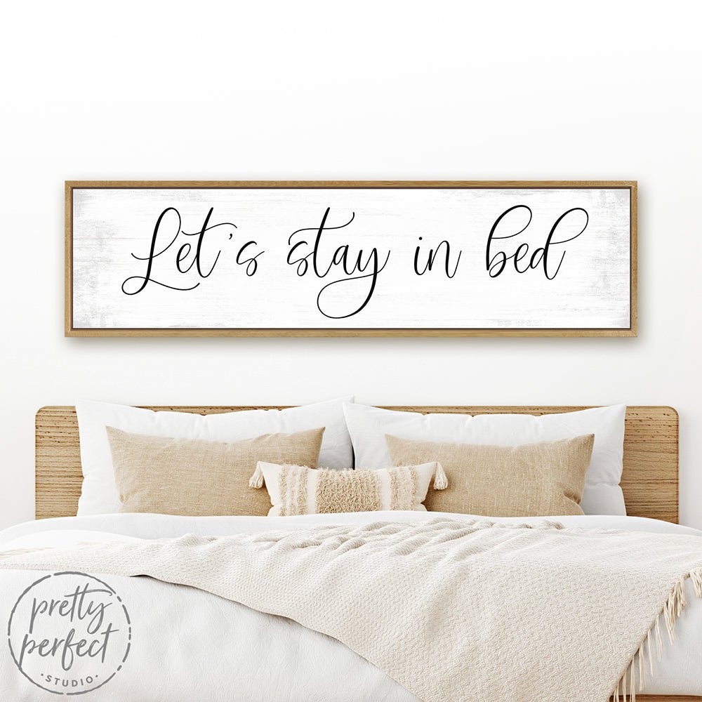 Let's Stay In Bed Sign Hanging on Wall Above Bed - Pretty Perfect Studio