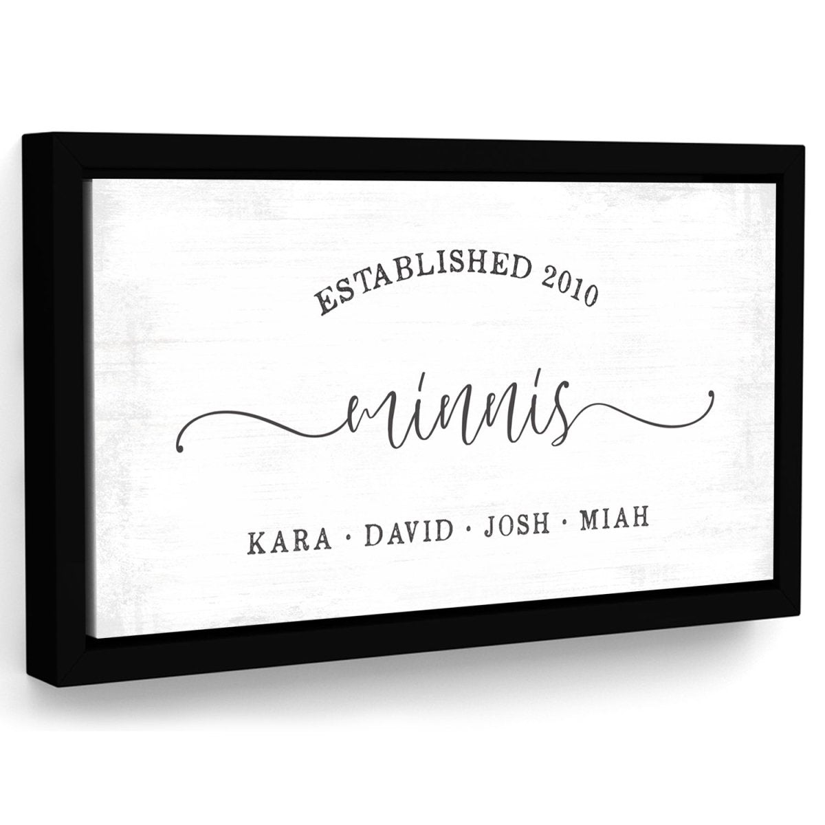 custom family name canvas wall art with last name, established date, and family members names in modern rustic style on lightly distressed background with black frame, angled view