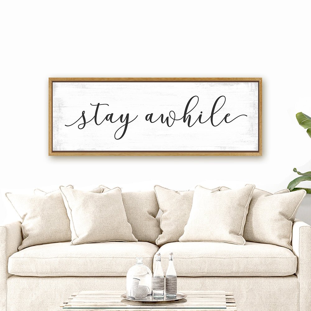 Stay Awhile Canvas Sign Hanging Above Couch - Pretty Perfect Studio