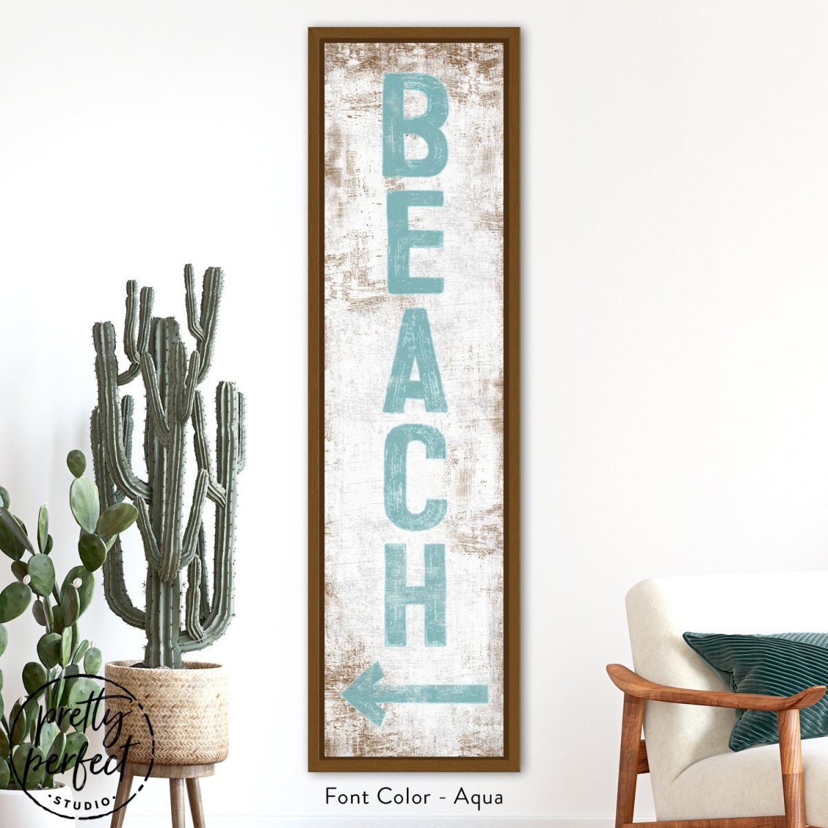 Beach sign wall art styled in a bedroom with soft neutral decor