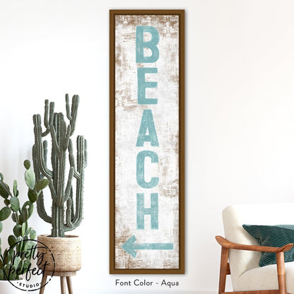 Beach sign wall art styled in a bedroom with soft neutral decor
