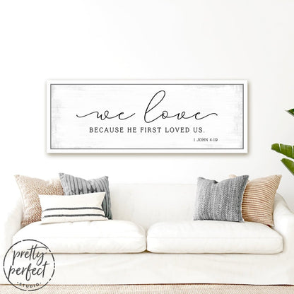 We Love Because He First Loved Us Bible Scripture Sign Hanging on Wall Above Couch - Pretty Perfect Studio